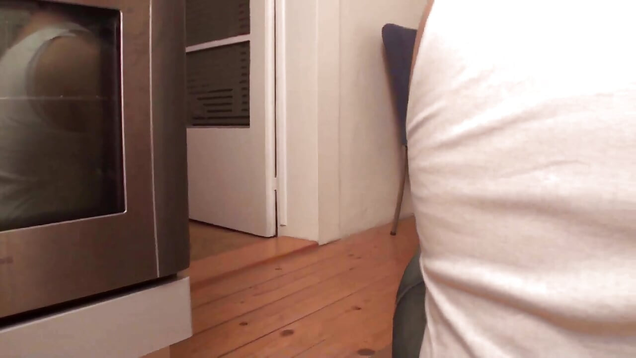 Richie kneels in the kitchen