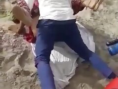 Two men have sex with a Rajasthani woman in an open field