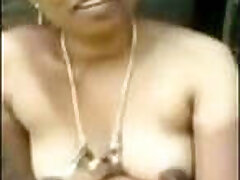 A Telugu auntie secretly walks with a dewar outdoors