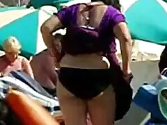 An aunt undresses on a foreign beach